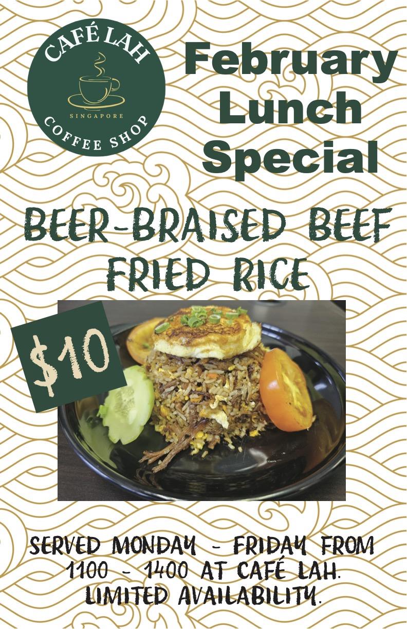 A plate of fried rice with tomato and cucumber with a fried egg. 